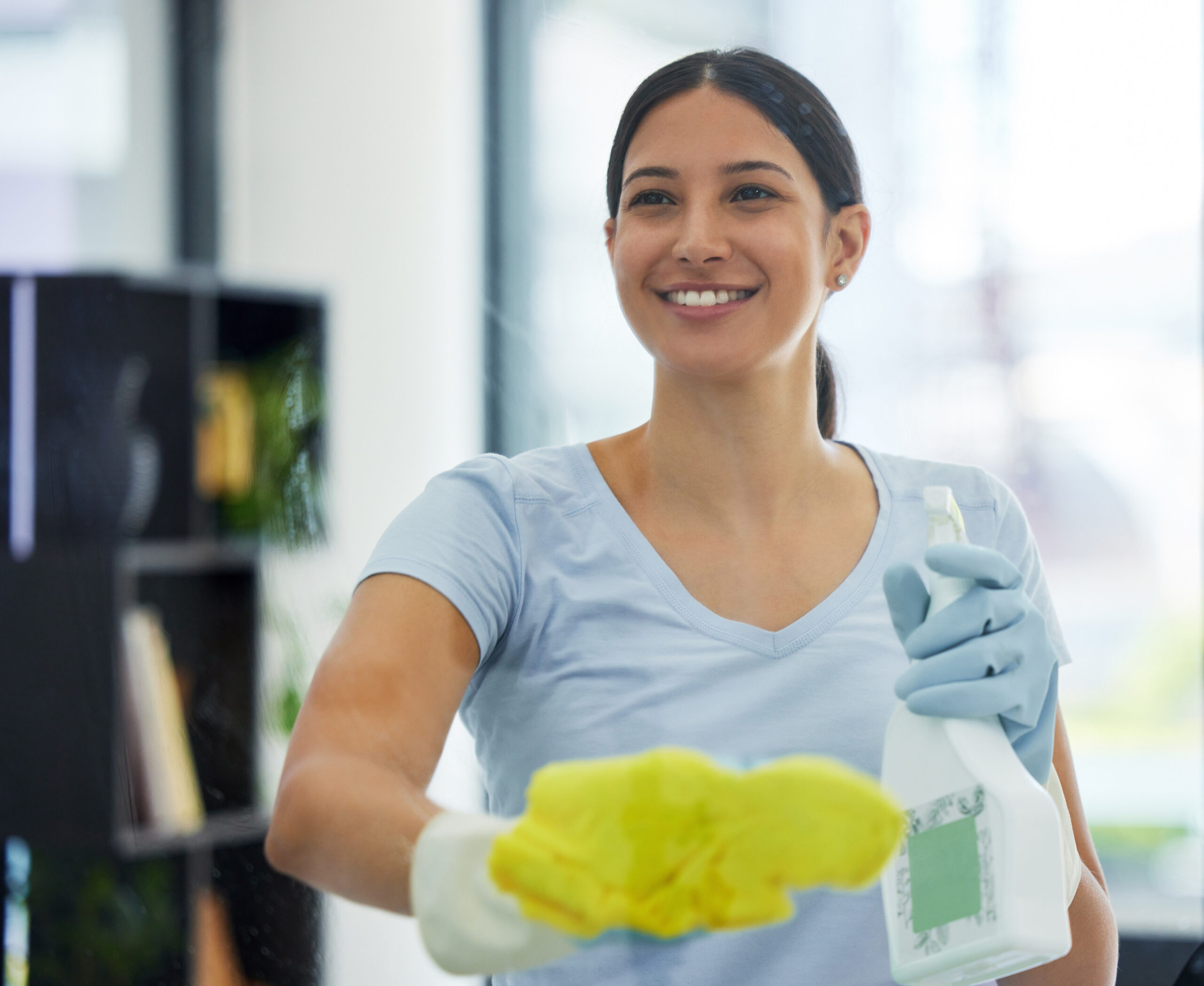 happy woman cleaning glass with bottle gloves detergent housekeeping home office cleaner service female domestic cleaner with product bacteria dust germ prevention scaled